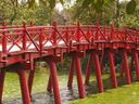A beautiful, wooden bridge brings pilgrims to the island temple on Hoan Kiem Lake.